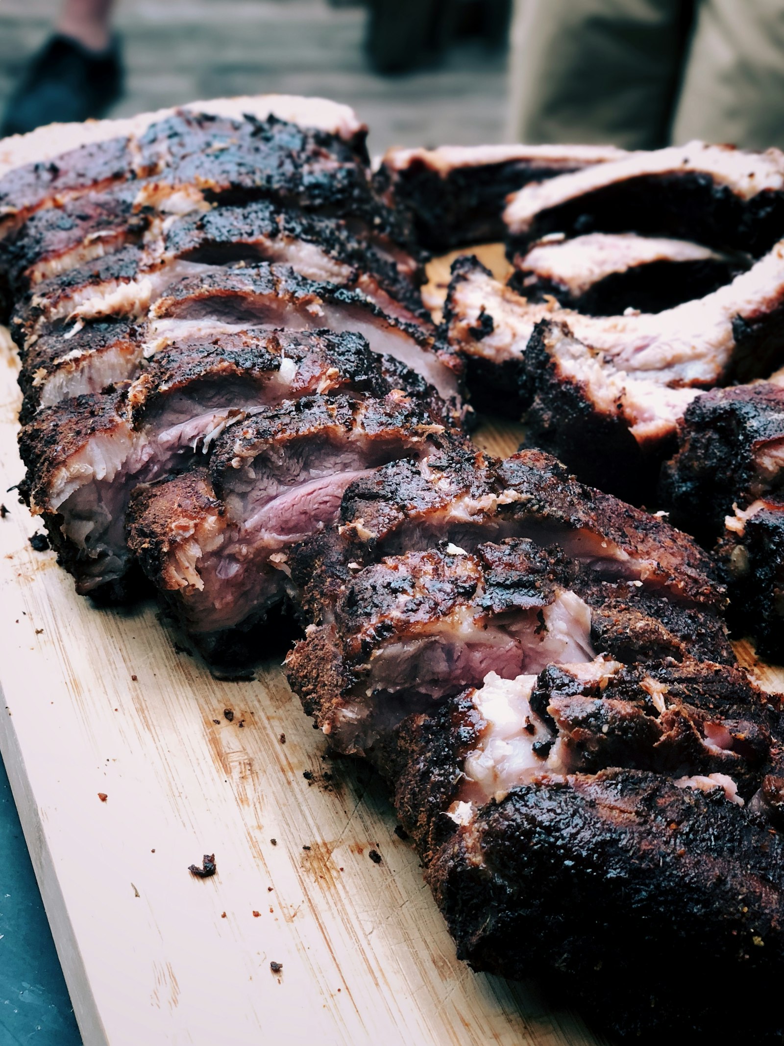Charred smoked ribs sliced on a board