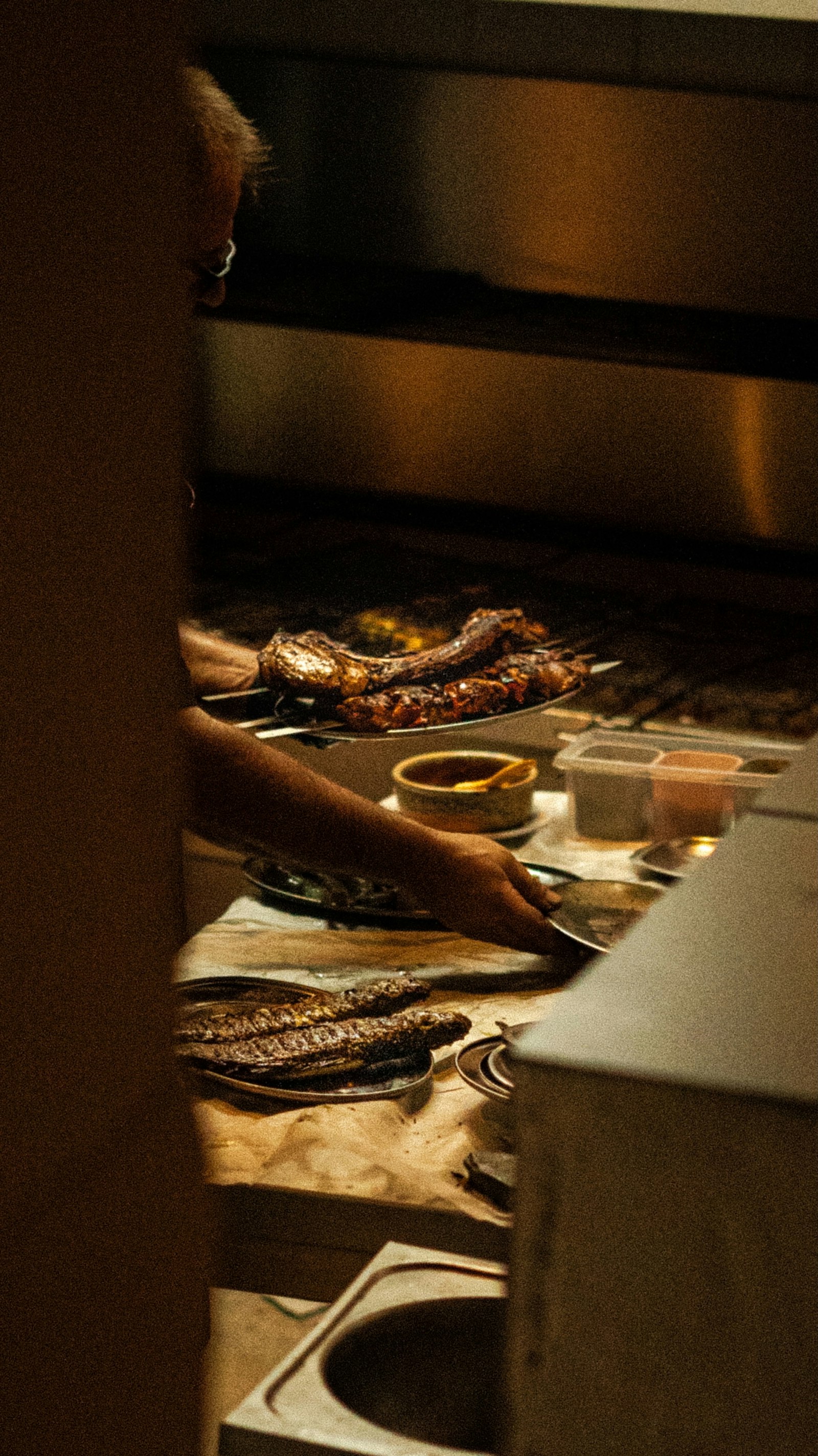 Chef working the grill in low light