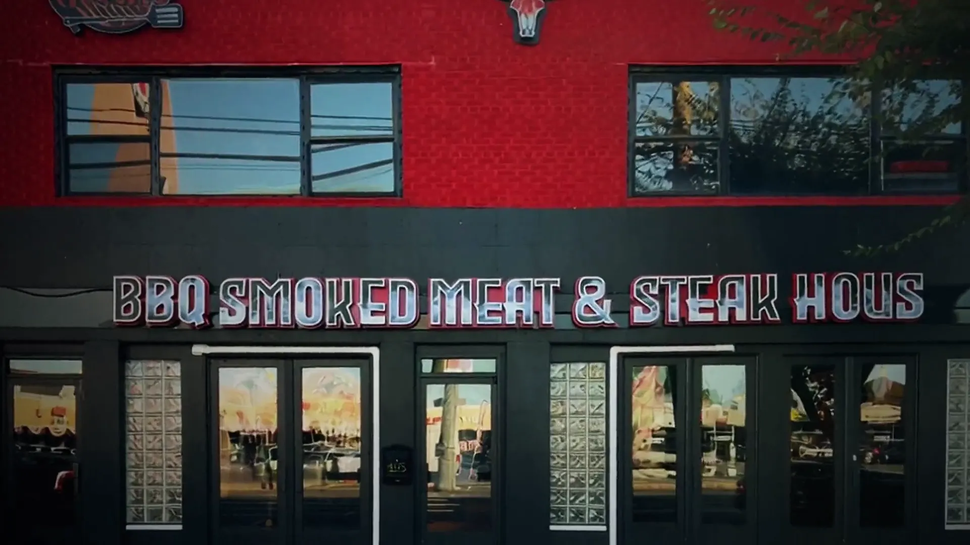 The red brick storefront of Rooh's BBQ Smoked Meat & Steak House on Hempstead Turnpike